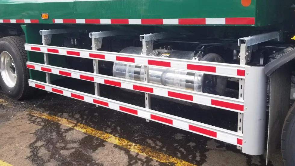 A green truck with a red and white stripe on the side.