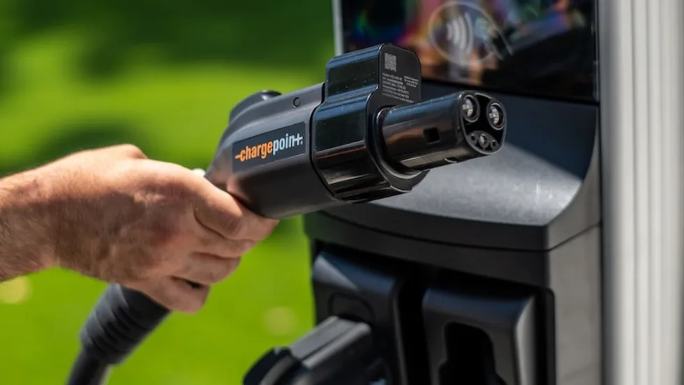 Hand gripping EV charger