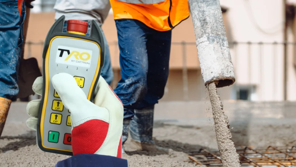 Photo of a remote control controlling the flow of concrete on a job site.