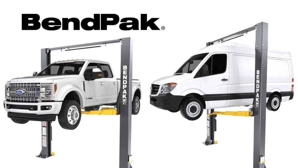 A white pickup truck and a white van each on an automotive lift.