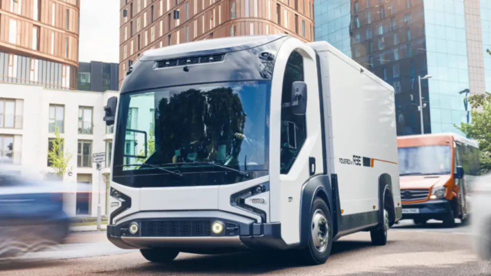 Futuristic-looking box truck driving down a street.
