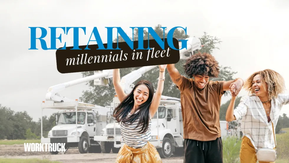 Happy millennials in front of work trucks