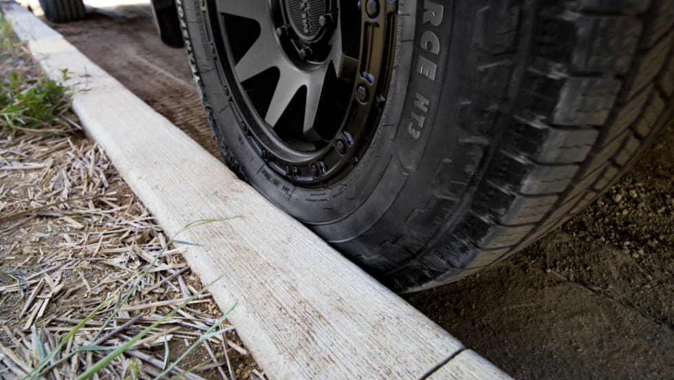 Truck tire scrubbing against a curb.