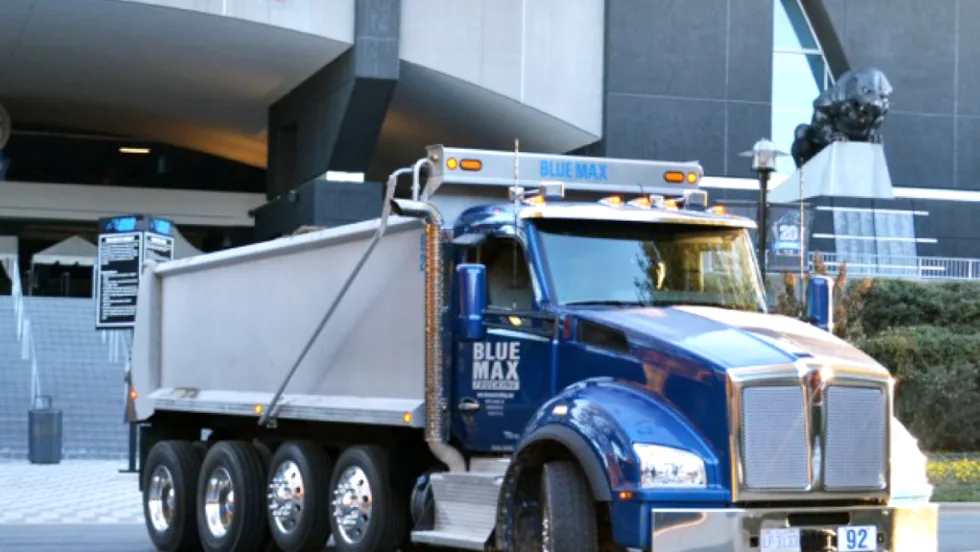 Photo of blue dump truck.