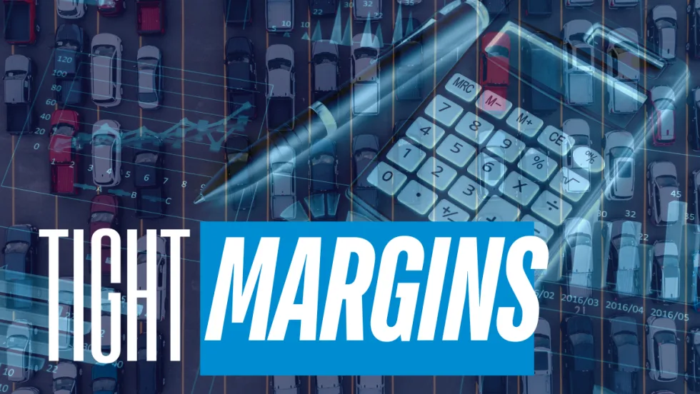 Aerial view of a crowded parking lot with financial graphics, calculator, and pen overlayed, illustrating tight fleet margins and cost pressure.