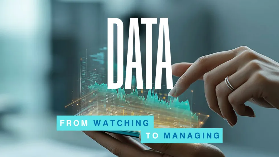A hand interacts with a digital data display above a smartphone, symbolizing how fleets use real-time insights to manage trucks, drivers, and daily operations.