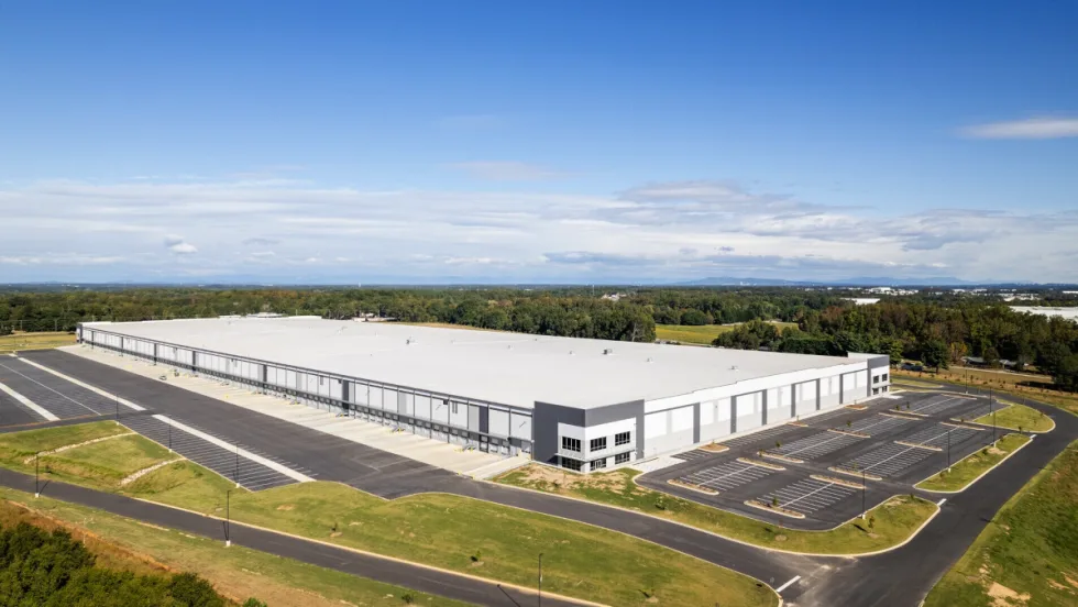 Aerial view of a large white manufacturing building.