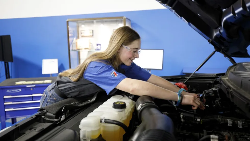 Makenna Enga working on a vehicle