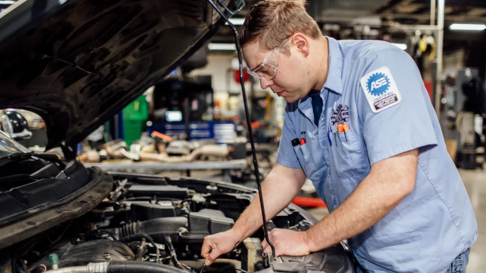 ASE technician working on a vehicle