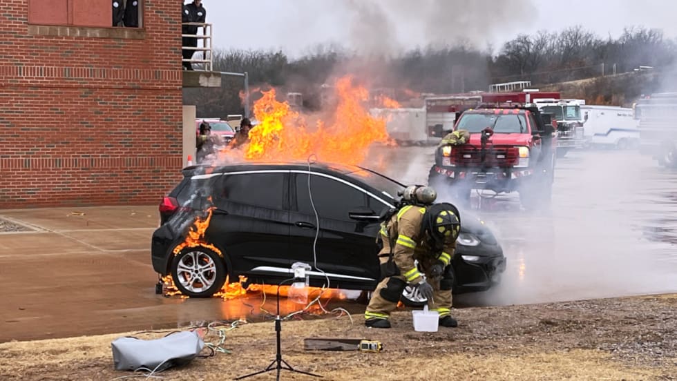 Firefighter fighting an EV car fire.