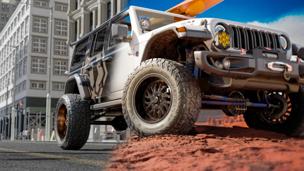Low-angle photo of a Jeep with aggressive off-road tires parked on top of a dirt mound.