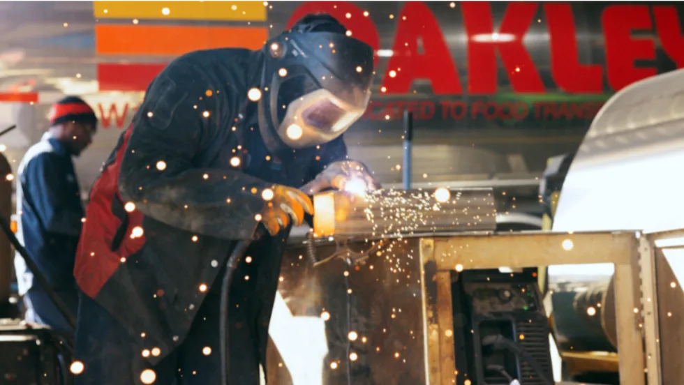 Worker is shown welding in a maintenance job in transportation industry.