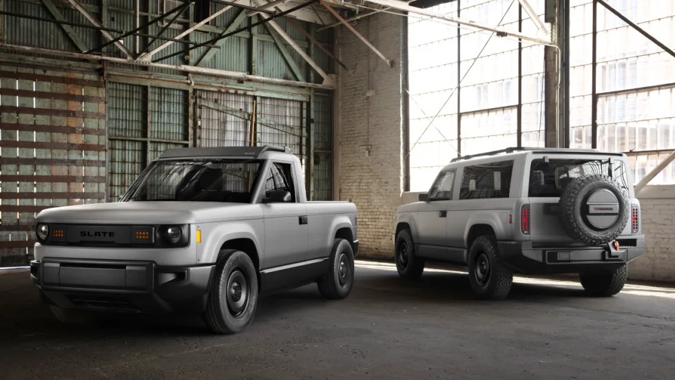 Image of gray compact pickup truck and SUV parked in an old warehouse.