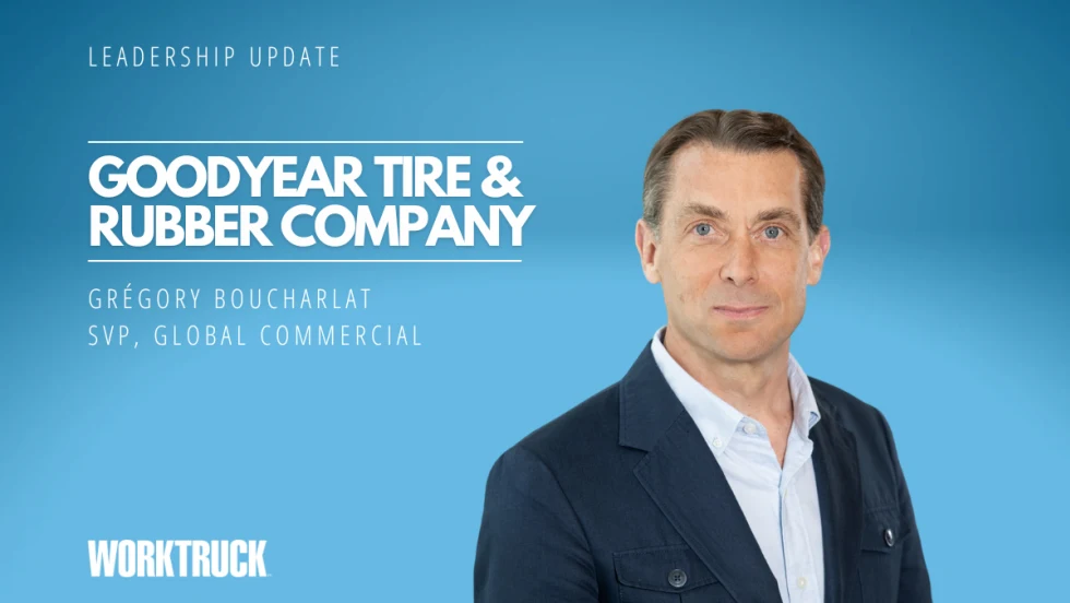 Man in business attire against a blue background, white text says
Goodyear Tire & Rubber Company and the man's name.