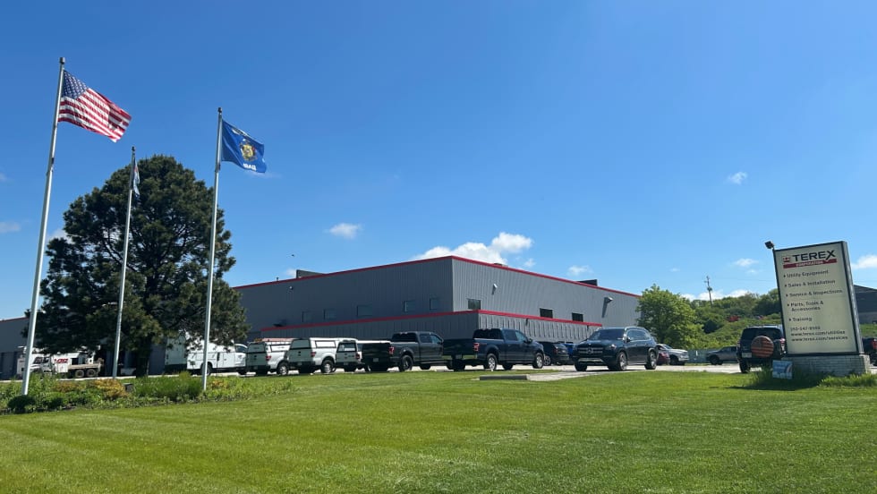 External photo of an industrial building against a blue sky.