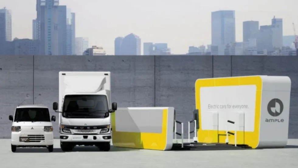 Graphic image showing two Mitsubishi commercial trucks and an EV battery swapping system.