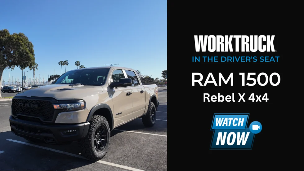 2025 Ram 1500 Rebel X 4x4 parked near marina with palm trees, featuring Mojave Sand paint, black grille, and off-road tires in a Work Truck video series spotlight.