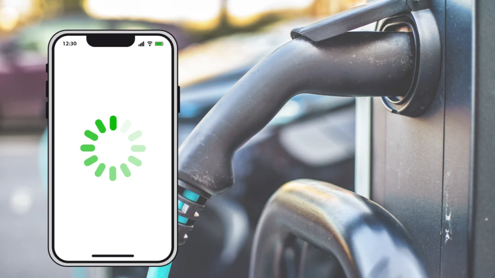 A smartphone with a loading icon displayed on the screen appears in front of an electric vehicle charging station, symbolizing delays or connectivity issues with EV mobile apps.