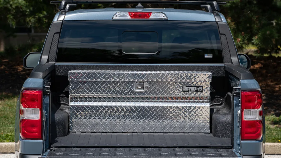 Photo of a tool box installed in the rear of a compact pickup truck, as viewed form rear with tailgate down.