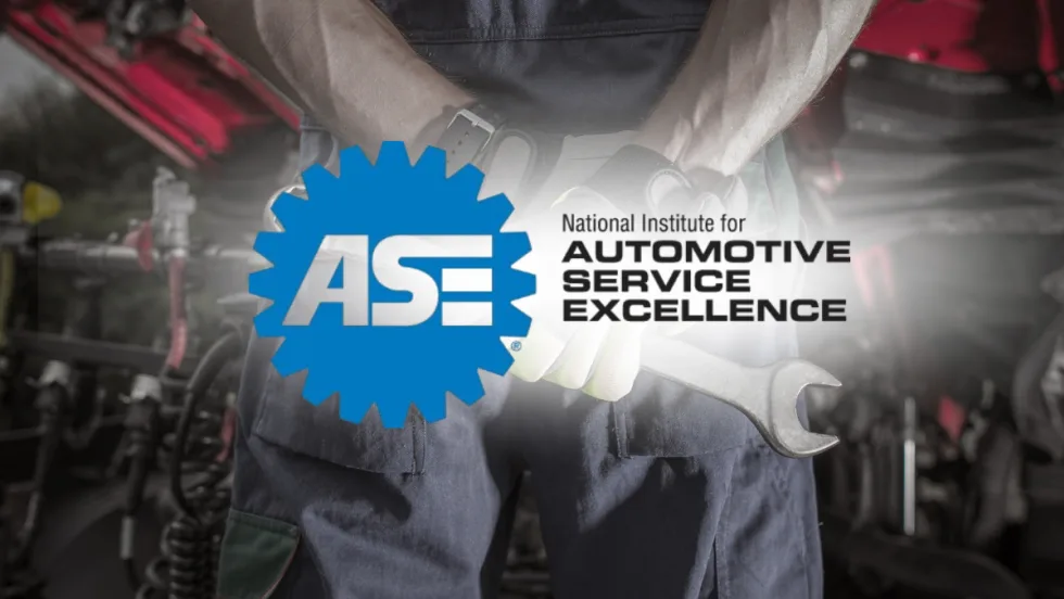 Technician holding wrench with ASE logo — ASE to discontinue five certification tests, including truck equipment and exhaust, by December 31, 2025.