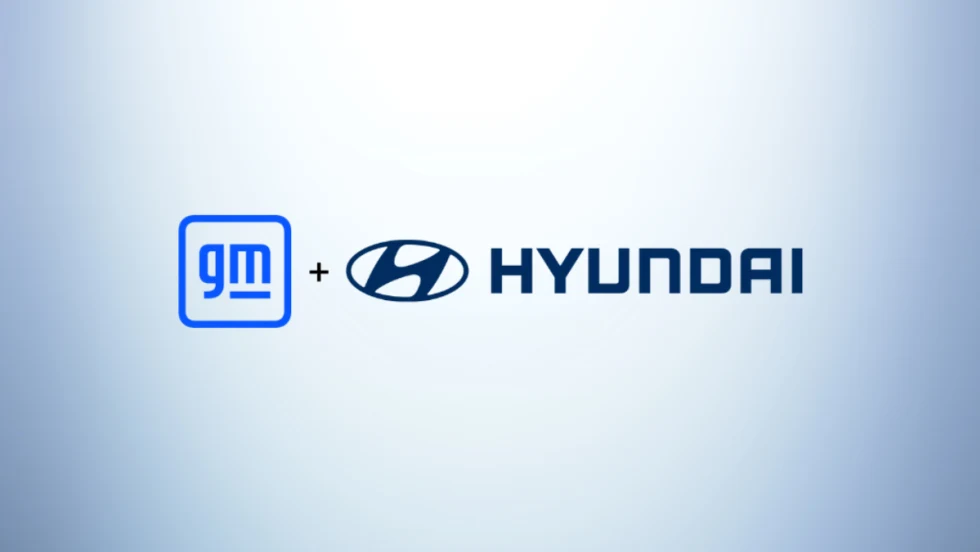 General Motors and Hyundai logos side by side on a light blue gradient background, representing a collaboration between the two automakers.