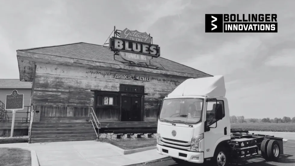 Bollinger Innovations electric cab chassis truck parked outside the Gateway to the Blues Visitors Center in Tunica, Mississippi, with the historic sign and building in the background.