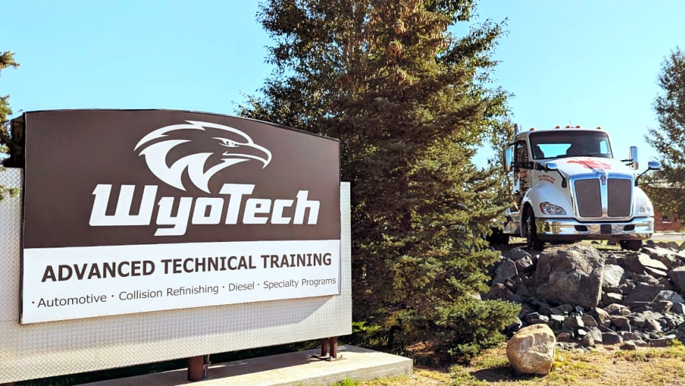 Photo of WyoTech training school sight at left and a Kenworth truck parked in the background to the right.