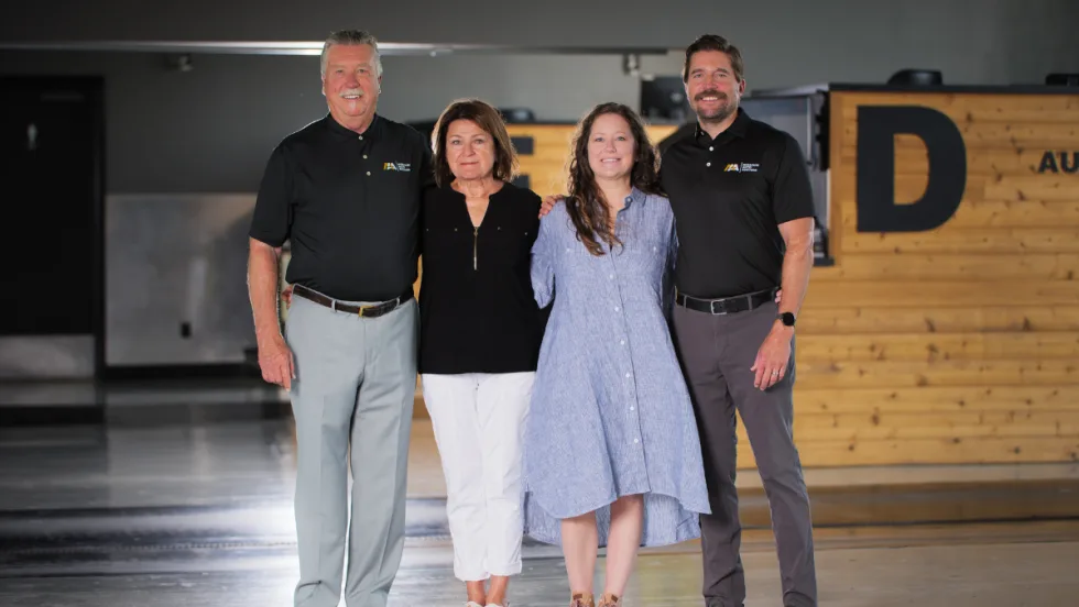 The Boswell family stands together inside Missouri Auto Auction, marking the company’s 25th anniversary.