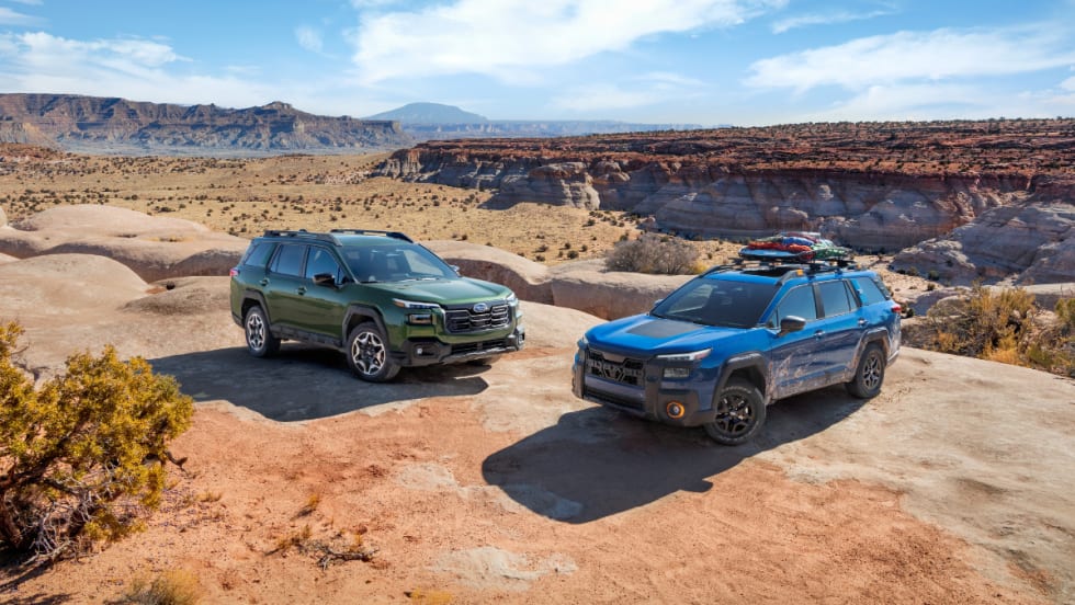 Two 2026 Subaru Outback SUVs parked on desert terrain, showcasing redesigned styling and adventure-ready utility.