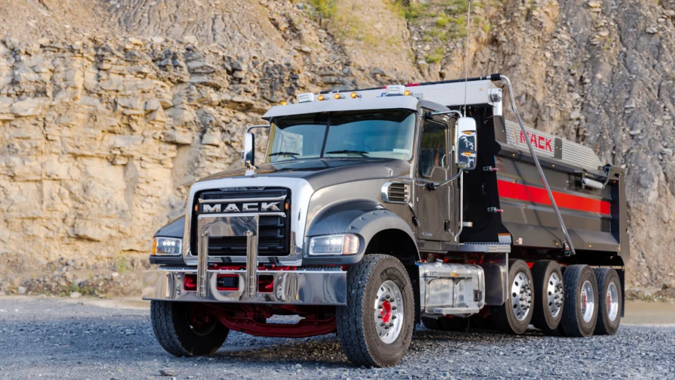 Mack dump  truck in a quarry setting.