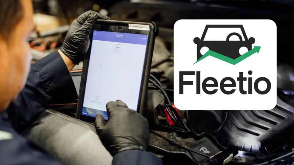 Automotive technician over an engine and using a tablet, inset logo at right for Fleetio, set against a white background box.