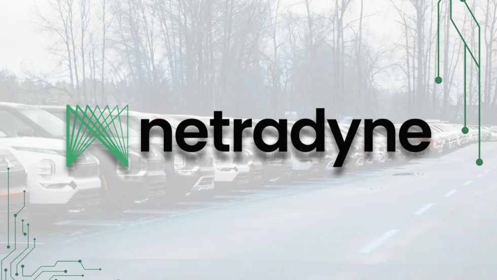 The Netradyne logo displayed over a faded background of parked fleet vehicles, with circuit-style graphics framing the corners to emphasize technology and connectivity.