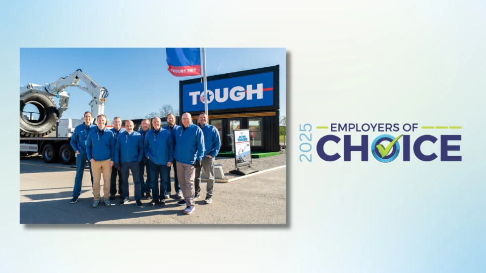 A group of Stellar employees in blue jackets stand in front of company signage and equipment, celebrating the 2025 Employer of Choice award.