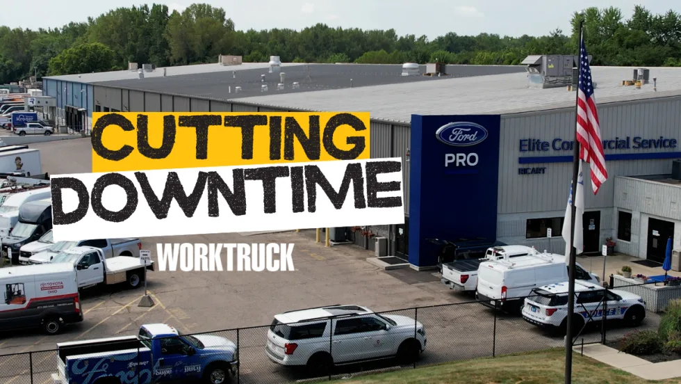 Exterior of Ford Pro Elite Commercial Service Center with Cutting Downtime sign and work trucks outside.