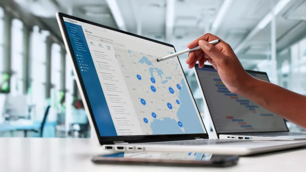 Drivewyze Safety+ Site Visits Map View displayed on a laptop, showing U.S. fleet safety events and hotspots for managers to monitor risks and driver activity.