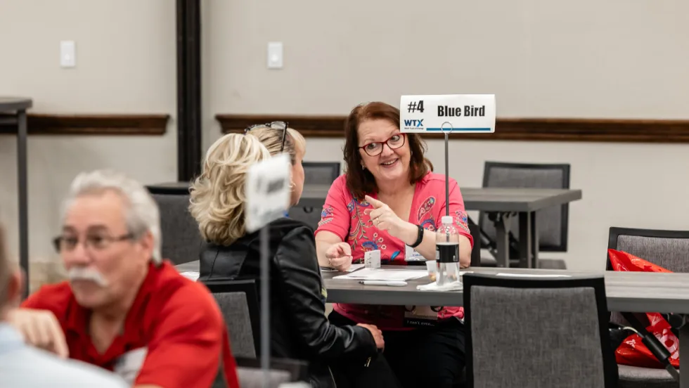 attendees share a lively discussion during a scheduled Work Truck Exchange appointment.