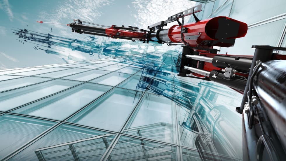 Creative photo looking upward showing the side of a glass building and an articulated truck crane reaching toward the top.