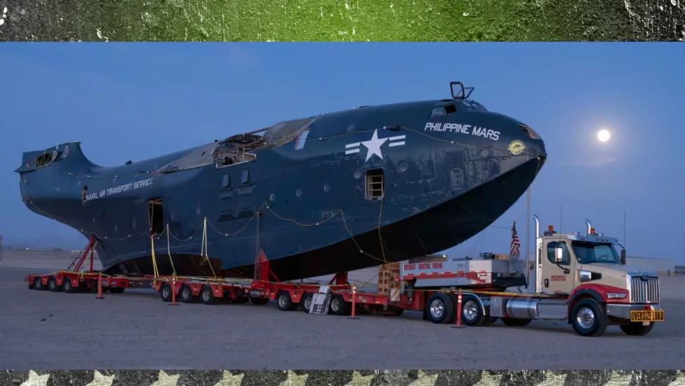 Western Star 49X truck towing the massive Philippine Mars flying boat at night under a full moon during its move to the Pima Air & Space Museum.