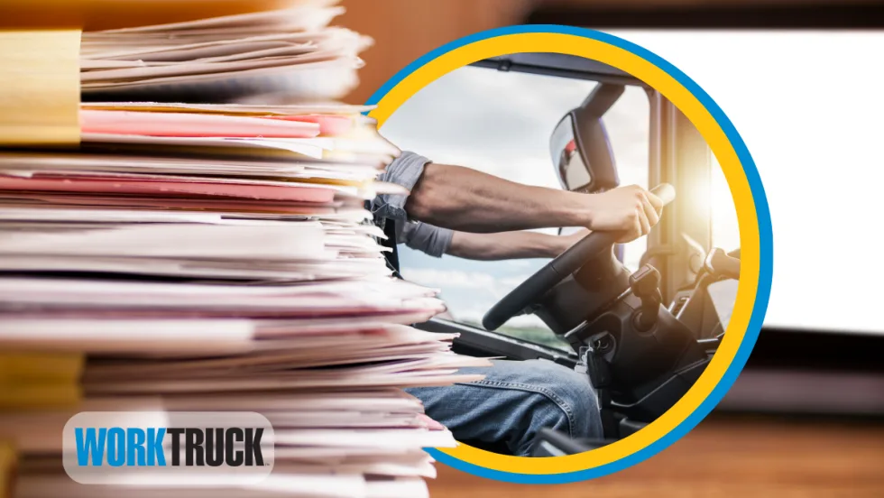 Stack of files and folders with a computer screen in the background and an inset oval photo of truck driver grasping a steering wheel.