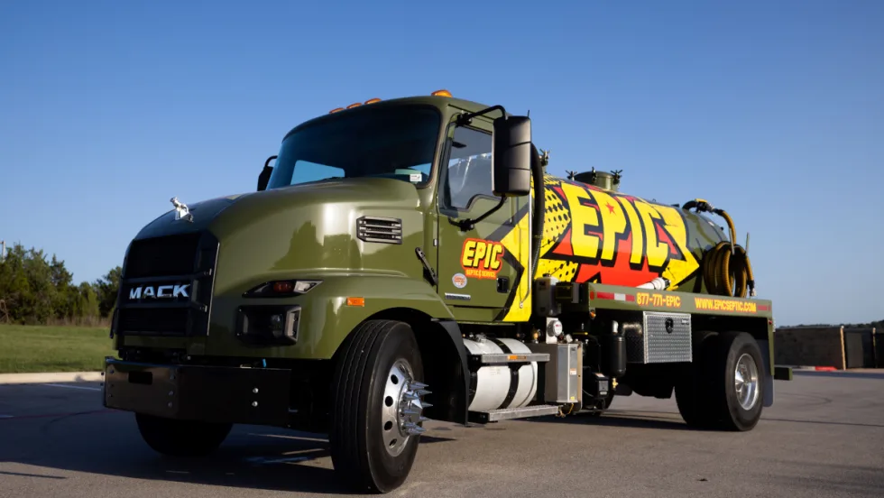 Army green septic tanker truck with yellow Epic logo on the side.