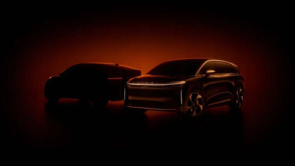 Two Lucid electric vehicles silhouetted in orange light, symbolizing the company’s partnership with NVIDIA to advance autonomous driving technology.
