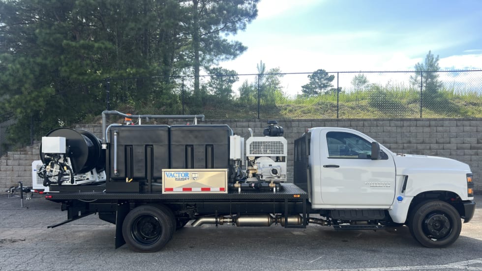 Photo of a dual hose reel mounted on the back of a work truck for sewer cleaning.