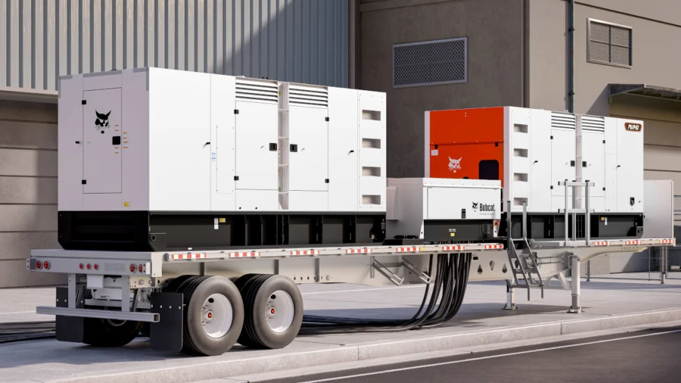 Side view of a flatbed trailer with two large mobile generators.