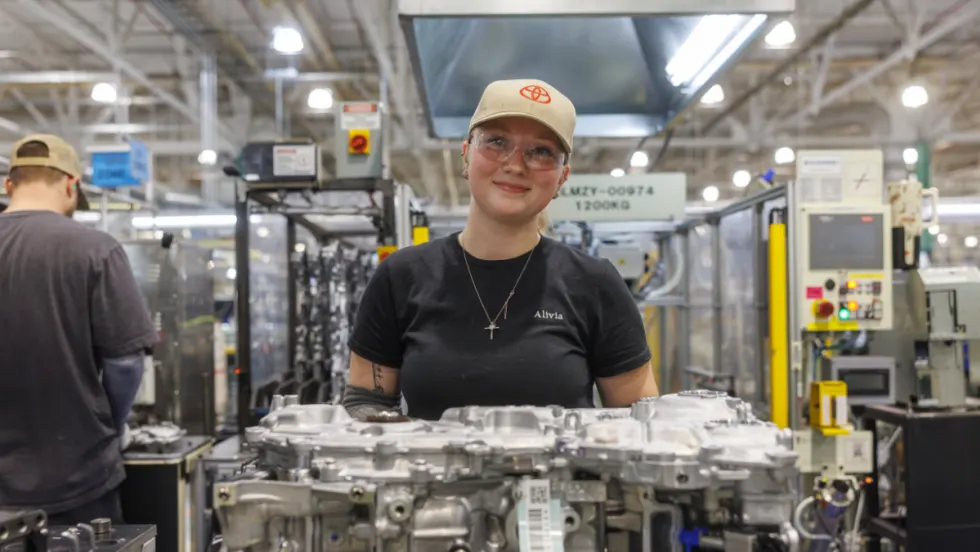 Toyota manufacturing employee assembling hybrid powertrain components on the factory floor as part of the company’s expanded U.S. hybrid production investment.