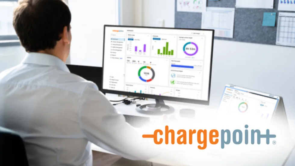 Person at a desk viewing a computer monitor with ChargePoint analytics dashboards; ChargePoint logo appears on the image.