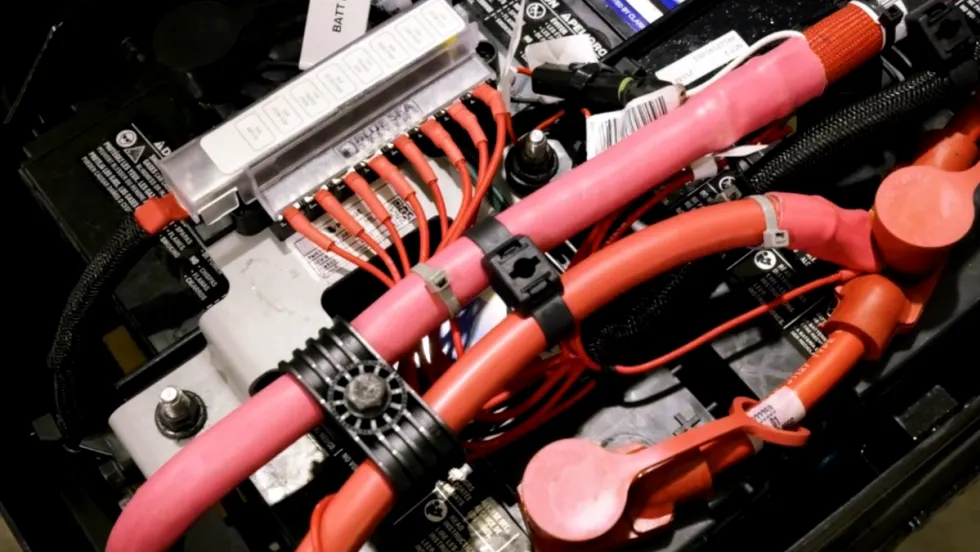 red battery cables on top of battery and engine