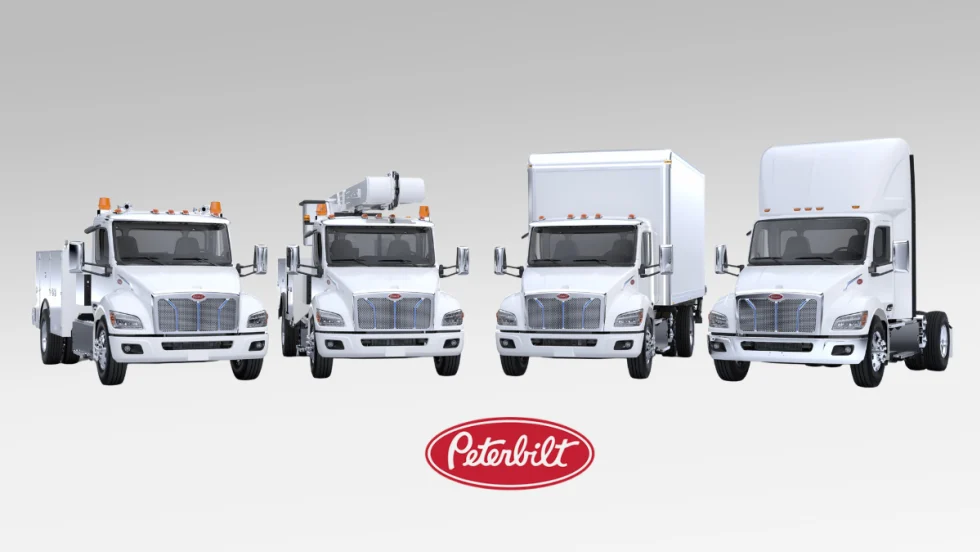 Four white battery electric trucks of varied sizes parked facing the camera against a gray gradient background with red oval Peterbilt logo bottom middle.