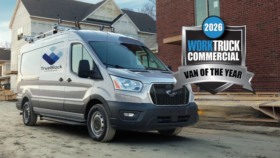 Ford Transit commercial van parked at a jobsite with Work Truck 2026 Commercial Van of the Year badge.