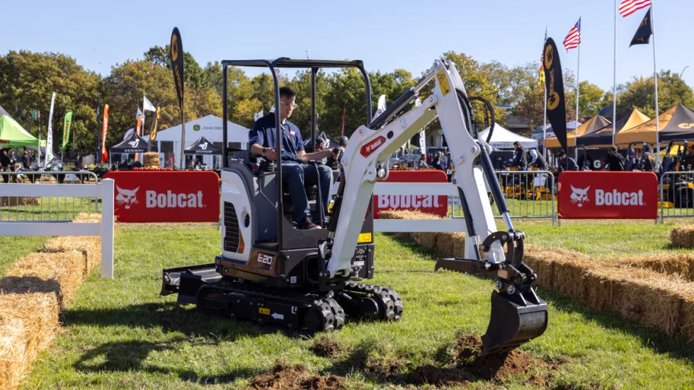 Bobcat excavator digging in the ground.