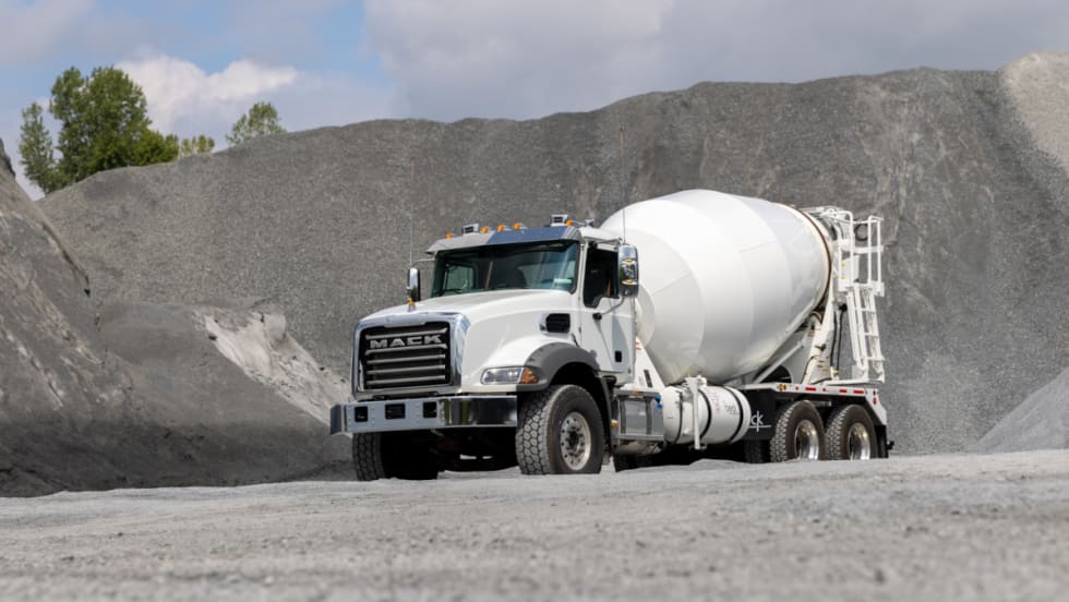 White concrete truck driving off road.